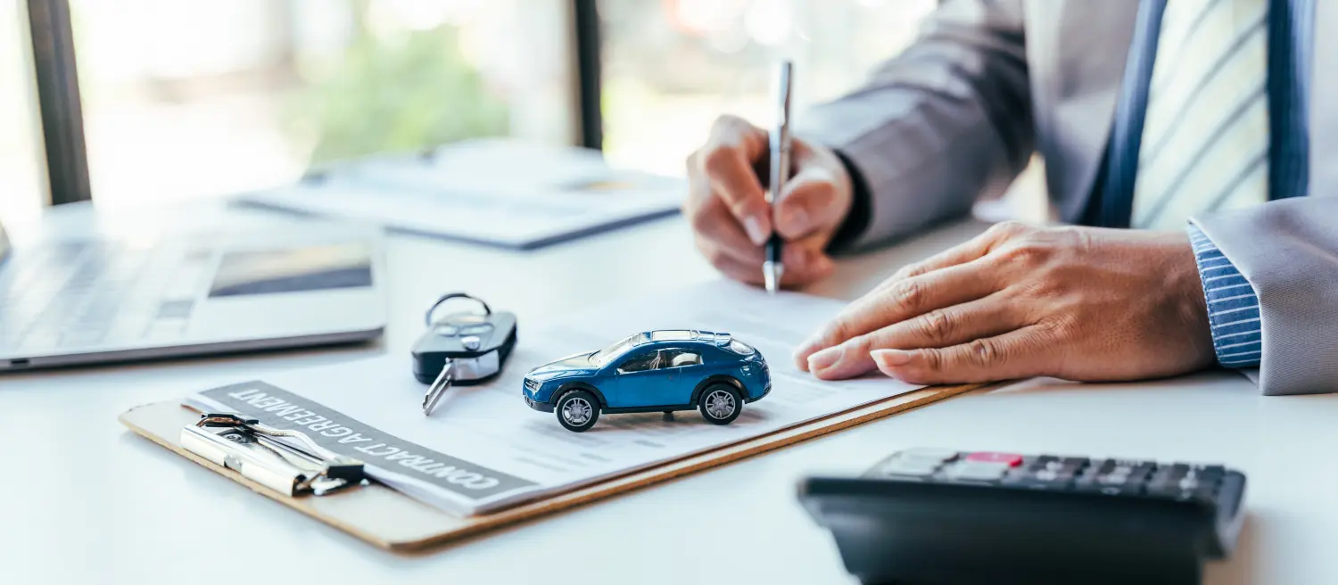 Mann unterschreibt Autoversicherungs- oder Leasingvertrag. Unterschrift auf Vertrag oder Vereinbarung schreiben.